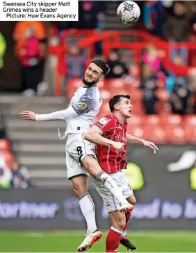  ?? ?? Swansea City skipper Matt Grimes wins a header
Picture: Huw Evans Agency