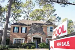  ?? Melissa Phillip/Houston Chronicle via AP, File ?? ■ A real estate sign is shown at a home for sale Jan. 13 in Houston.