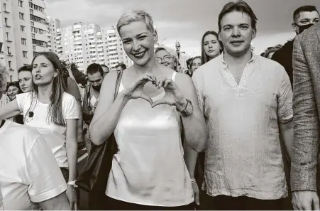  ?? Associated Press ?? Maria Kolesnikov­a, one of Belarus’ opposition leaders, center, gestures, during a rally in Minsk. The profession­al flute player emerged as a key opposition activist in Belarus protesting against authoritar­ian President Alexander Lukashenko.