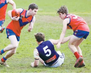  ??  ?? Buln Buln’s Tim Davine comes away with the ball following a contest between teammate Harry Wans and Catani’s Cody Banbury