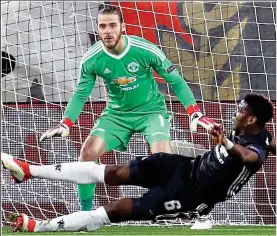  ?? EPA ?? Doing his bit: Pogba helps De Gea by clearing the ball