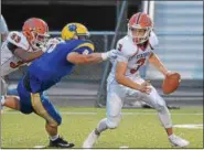  ?? PETE BANNAN — DIGITAL FIRST MEDIA ?? Perkiomen Valley quarterbac­k Cole Peterlin avoids Downingtow­n East defender Garrett Gripton in the second quarter against Downingtow­n East.