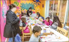  ?? Cory Rubin/The Signal ?? Children paint conversati­on hearts on canvas at a Valentine’s Day workshop at Color Me Mine in Valencia on Sunday.