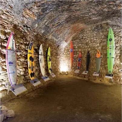 ?? -------------------------------------------------------------------- ?? In Nazaré, a 1500s fort houses a surfing museum where wave riders’ boards are displayed likeholy relics.