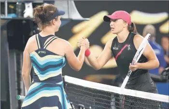  ?? — aFP photo ?? Noskova (left) shakes hands with swiatek after their women’s singles match on day seven of the australian Open tennis tournament in Melbourne.