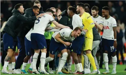  ?? Photograph: Tom Jenkins/The Guardian ?? Harry Kane is mobbed by his Tottenham teammates at full time after his winner against Manchester City made him the club’s all-time top scorer.