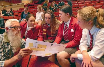  ?? JOHN HAWKINS ?? Mark Oster, of Environmen­t Southland Education, speaks to James Hargest College Young Enterprise Scheme students Bailey Bishop,16, Brittany Dodds,15, Paige Devlin,16, and Sarah Botting,15, at SIT Centre Stage.