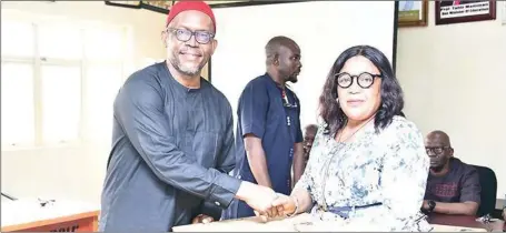  ?? ?? The Provost, Federal College of Education (Technical), Umunze, Anambra, Prof. Theresa Okoli, presenting a laptop to the Vice President, Colleges of Education Academic Staff Union, Dr. Churchill Okonkwo as part of the the Revitalisa­tion Programme... recently