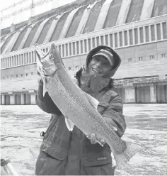  ?? PHOTOS BY GARY GARTH FOR USA TODAY ?? Joe Marra holds a steelhead trout pulled from the Niagara River near the Niagara Hydroelect­ric Power Station.