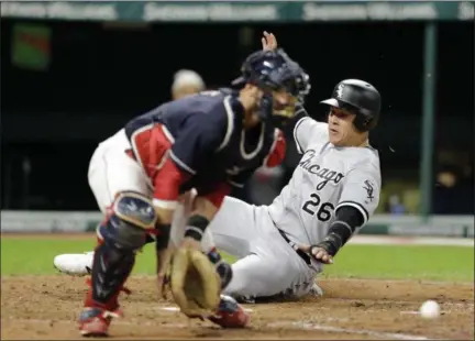  ?? TONY DEJAK — THE ASSOCIATED PRESS ?? Chicago’s Avisail Garcia scores as Indians catcher Yan Gomes waits for the ball in the sixth inning on Sept. 30 at Progressiv­e Field. Garcia scored on a one-run double hit by Kevan Smith.