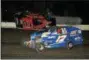  ?? RICK KEPNER - FOR DIGITAL FIRST MEDIA ?? Dan Waisempach­er (01) gets up the wall and flips as Ryan Grim (17) passes by during the modified feature at Grandview on May 5.