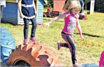  ?? DESIREE ANSTEY/ JOURNAL PIONEER ?? Brinley MacKenzie jumps from tire to tire.