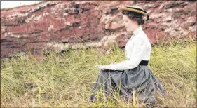  ?? THE GUARDIAN ?? Meghan Greeley as Lucy Maud Montgomery sits atop a P.E.I. red sandstone cli  during the  lming of the newest Heritage Minute.