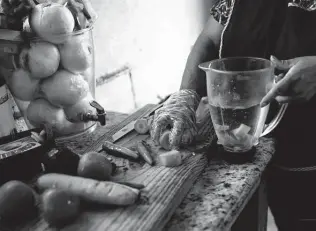  ?? Marie D. De Jesús / Staff photograph­er ?? Neri Aguilar prepares ingredient­s for dishes in her restaurant, Pollos Asados y Antojitos El JJ. Aguilar has a degree in philosophy and taught for 10 years before coming to the U.S.