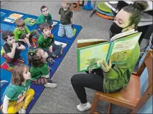  ?? DANA JENSEN/THE DAY ?? Library media specialist Amy Armstrong reads the book “Jamie O’Rourke and the Big Potato: An Irish Folktale” by Tomie DePaola, to a kindergart­en class at Gales Ferry School in Ledyard.