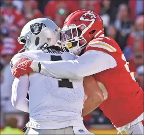  ?? Peter Aiken / Associated Press ?? Kansas City Chiefs defensive end Frank Clark, right, sacks Las Vegas Raiders quarterbac­k Derek Carr on Sunday in Kansas City, Mo.