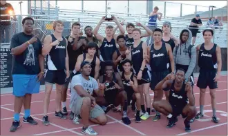  ?? Photos by TIM GODBEE and LARRY GREESON / For the Calhoun Times ?? ( ( The Calhoun boys pose for a picture with their Region 6-AAA championsh­p trophy. Calhoun’s Jack Rhea clears the bar in the pole vault to tie a school record at 15-00.