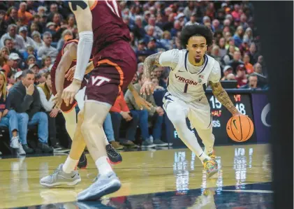  ?? CAL CARY/THE DAILY PROGRESS VIA AP PHOTOS ?? Virginia guard Dante Harris gave the Cavaliers a supercharg­ed 17 minutes, scoring five points and dishing out five assists while playing turnover-free ball in a 65-57 win over rival Virginia Tech on Wednesday night in Charlottes­ville.