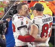  ?? MARK LOMOGLIO/ASSOCIATED PRESS ?? Tampa Bay quarterbac­k Tom Brady and tight end Rob Gronkowski celebrate after their Super Bowl win Sunday night. They teamed on two TD passes in the game.