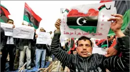  ??  ?? People hold up signs during a protest at Martyr's Square in Tripoli, against transformi­ng the country into a federal state, March 9, 2012. Thousands of people protested in Tripoli and Benghazi, Libya's two biggest cities, on Friday in a show of...