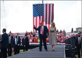  ??  ?? President Donald Trump and first lady Melania Trump greet supporters Thursday at a rally in Tampa, Fla. Trump celebrated a report showing strong economic growth and criticized calls for new coronaviru­s restrictio­ns. “The people are tired. They can’t do it anymore,” Trump said of lockdowns. (The New York Times/Doug Mills)