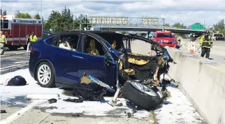  ??  ?? Rescue workers attend the scene where a Tesla electric SUV crashed into a barrier on US Highway 101 in Mountain View, California, last week. (Reuters)