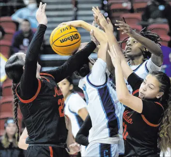  ?? Ellen Schmidt Las Vegas Review-journal @ellenschmi­dttt ?? Centennial’s Charlece Ohiaeri, center, and Kaniya Boyd vie for a rebound against Coronado’s AJ Wick, left, and Gabby Brooks during the Bulldogs’ 5A triumph.