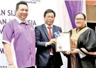  ??  ?? AHLI Lembaga Pengarah Ulink Ascot Sdn Bhd Yusak Yumboris @Misek Umbaris (tengah) menyampaik­an Anugerah Pelatih Terbaik kepada Amabel, sambil diperhatik­an oleh Steve (kiri).