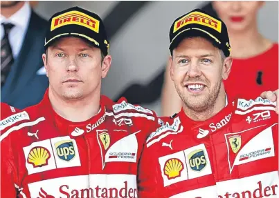  ?? Getty. ?? Mixed emotions: Kimi Raikkonen, left, and Sebastian Vettel on the podium after the Monaco Grand Prix. The Finn lost the lead to his Ferrari team-mate after pitting five laps earlier than him.