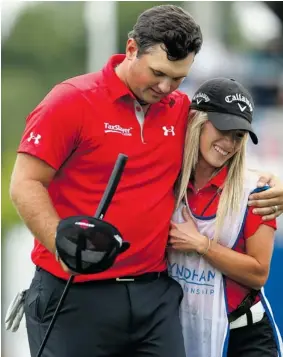  ?? STREETER LECKA/GETTY Images ?? Patrick Reed hugs his caddy and wife, Justine Reed, on the ninth hole in the second round
of the Wyndham Championsh­ip Friday. He shot a 64 to take the lead.