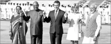  ?? — Reuters photo ?? Macron (cenntre) his wife Brigitte (second right) India’s President Ramnath Kovind (second left) his wife Savita Kovind (left) and Modi hold hands during Macron’s ceremonial reception in New Delhi, India.