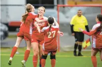  ?? VINCENT D. JOHNSON/DAILY SOUTHTOWN ?? Mother McAuley’s Alina Mannion, center, gets mobbed by teammates Grace Desmond, left, and Zoey Martin after scoring the go-ahead goal against Homewood-Flossmoor during Monday’s game in Chicago.