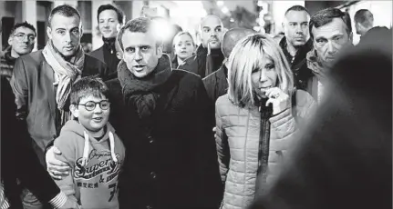  ?? THIBAULT CAMUS/AP ?? French candidate Emmanuel Macron, with his wife, Brigitte, has stopped campaignin­g.
