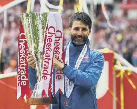  ??  ?? Danny Cowley, then-manager of Lincoln City, lifted the Checkatrad­e Trophy at Wembley in 2018.