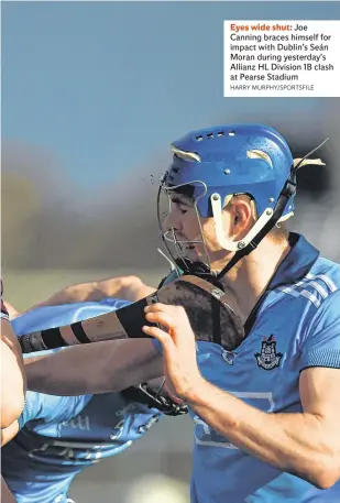  ?? HARRY MURPHY/SPORTSFILE ?? Eyes wide shut: Joe Canning braces himself for impact with Dublin’s Seán Moran during yesterday’s Allianz HL Division 1B clash at Pearse Stadium