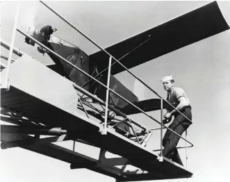  ??  ?? Aboard the gunnery training ship USS Wyoming in 1945, a sailor prepares to launch a Radioplane TDD target drone.