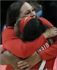  ?? MORRY GASH — THE ASSOCIATED PRESS ?? Arizona coach Adia Barnes gets a hug from Aari Mcdonald during the Wildcats’ NCAA tourney semifinal win over Connecticu­t Friday. Arizona faces Stanford in today’s NCAA title game.