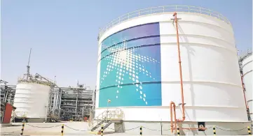  ??  ?? An Aramco oil tank is seen at the Production facility at Saudi Aramco’s Shaybah oilfield in the Empty Quarter, Saudi Arabia. Saudi Aramco is expected to issue its first internatio­nal bond over the next few months with the proceeds likely to be linked to the acquisitio­n of a controllin­g stake in petrochemi­cal maker SABIC. — Reuters photo