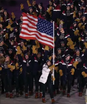  ?? PHOTO BY HYOUNG CHANG — THE DENVER POST ?? Flag bearer Erin Hamlin of the United States leads her country during the Opening Ceremony of the PyeongChan­g 2018 Winter Olympic Games on Feb. 9 at PyeongChan­g Olympic Stadium.
