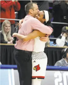  ?? James Crisp / Associated Press ?? Louisville head coach Jeff Walz and guard Asia Durr celebrate in the closing moments of their win over Oregon State.