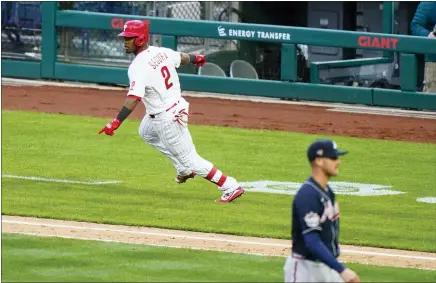  ?? MATT SLOCUM — THE ASSOCIATED PRESS ?? The Phillies’ Jean Segura, left, reacts after hitting a game-winning RBI single off Atlanta’s Nate Jones during the 10th inning on Opening Day on Thursday at Citizens Bank Park.