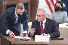  ?? — AFP photo ?? Morrison speaks with an aide at the first-ever in-person Quad Leaders Summit at the White House in Washington, DC recently.