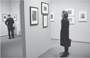  ??  ?? Visitors look at the exhibit ‘Imogen Cunningham: In Focus’ at the Museum of Fine Arts, Boston, on Wednesday. — Reuters photo