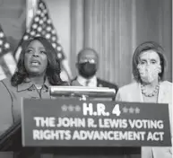  ?? SARAHBETH MANEY/THE NEW YORK TIMES ?? Speaker of the House Nancy Pelosi, right, D-Calif., listens as Rep. Terri Sewell, D-Ala., speaks about the John R. Lewis Voting Rights Advancemen­t Act at the U.S. Capitol in Washington last Tuesday.