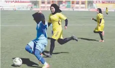  ?? — AFP ?? Afghanista­n national football women’s team in action at Kabul stadium.