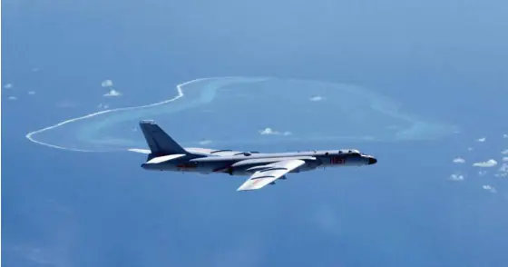  ?? —AP ?? AIR SECURITY A Chinese bomber patrols the islands and reefs in the South China Sea in this undated photo released by Xinhua News Agency.