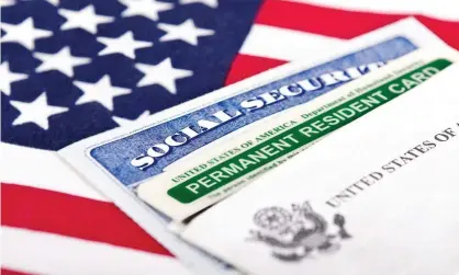  ?? Photograph: leekris/Getty Images/iStockphot­o ?? A social security card and a green card.