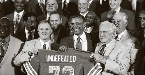  ?? Christophe­r Gregory / New York Times ?? Don Shula, right, and Bob Griese present President Barack Obama with a signed jersey in 2013 celebratin­g Miami’s historic 17-0 season in 1972.