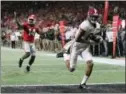  ?? CURTIS COMPTON — ATLANTA JOURNAL-CONSTITUTI­ON ?? Alabama wide receiver Devonta Smith runs into the end zone for the gamewinnin­g TD in overtime of the NCAA college football playoff championsh­ip game in Atlanta on Monday. Alabama won, 26-23.