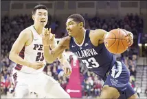  ??  ?? Jermaine Samuels #23 of the Villanova Wildcats drives to the basket against Michael Wang #23 of the Pennsylvan­ia Quakers in the first half atThe Palestra on Dec 11 in Philadelph­ia, Pennsylvan­ia. (AFP)